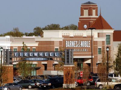 Valley Creek Shopping center entrance with Barnes & Noble, parked cars, and trees.