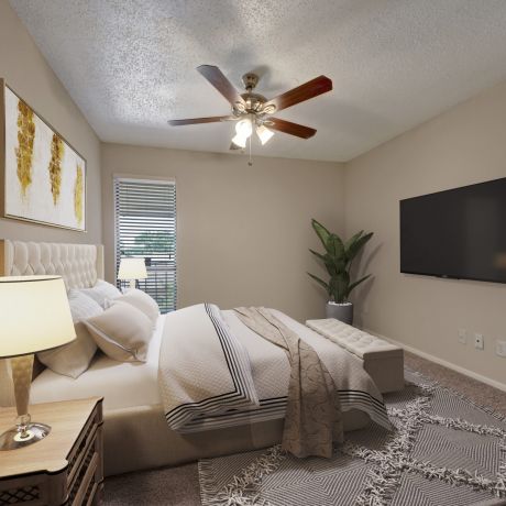 Valley Creek A cozy bedroom with a bed, lamp, large TV, ceiling fan, and potted plant, featuring neutral tones and natural light.