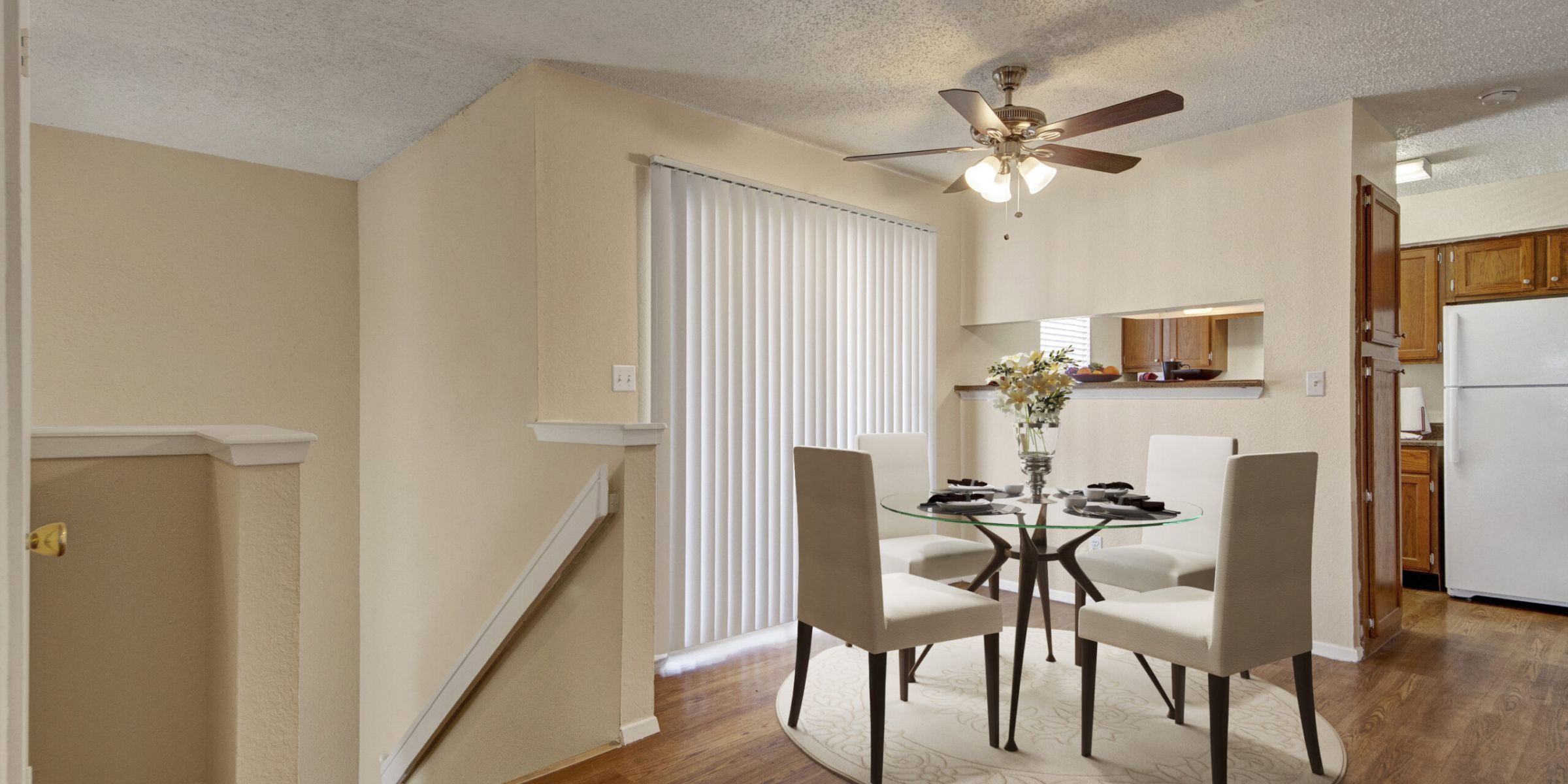 Luxury apartment living room with large windows, wood style floors and contemporary furniture at The Civic at Frisco Square